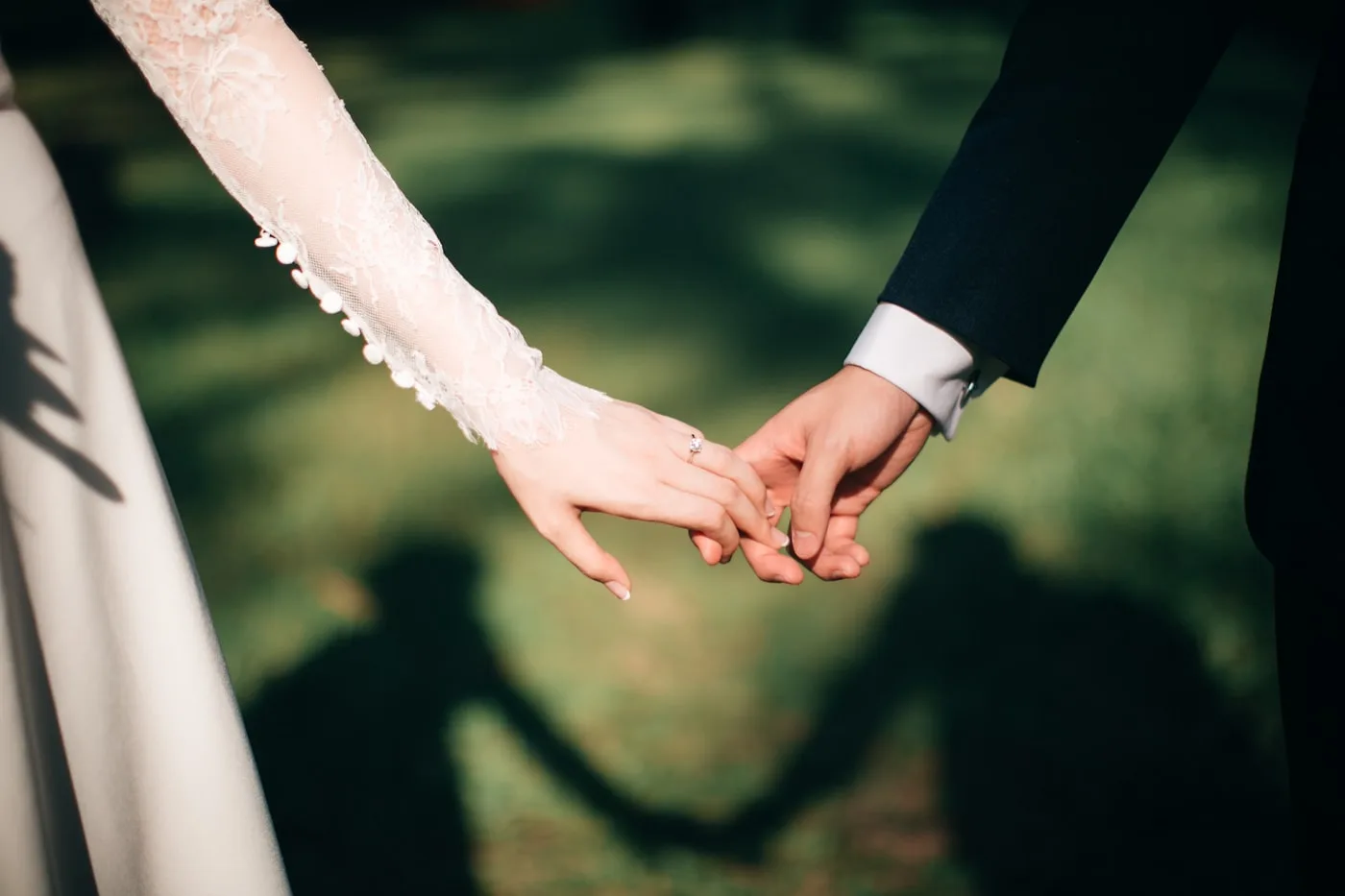 Wedding couple holding hands at the reception